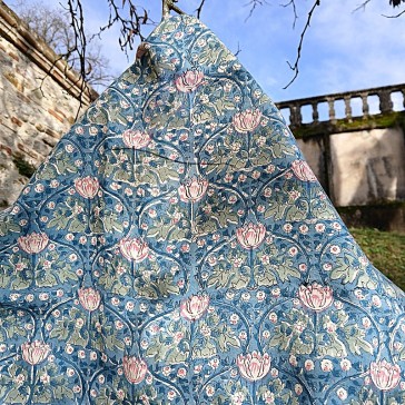 Coton indien entrelac de fleurs roses feuilles vertes sur fond bleu ciel.